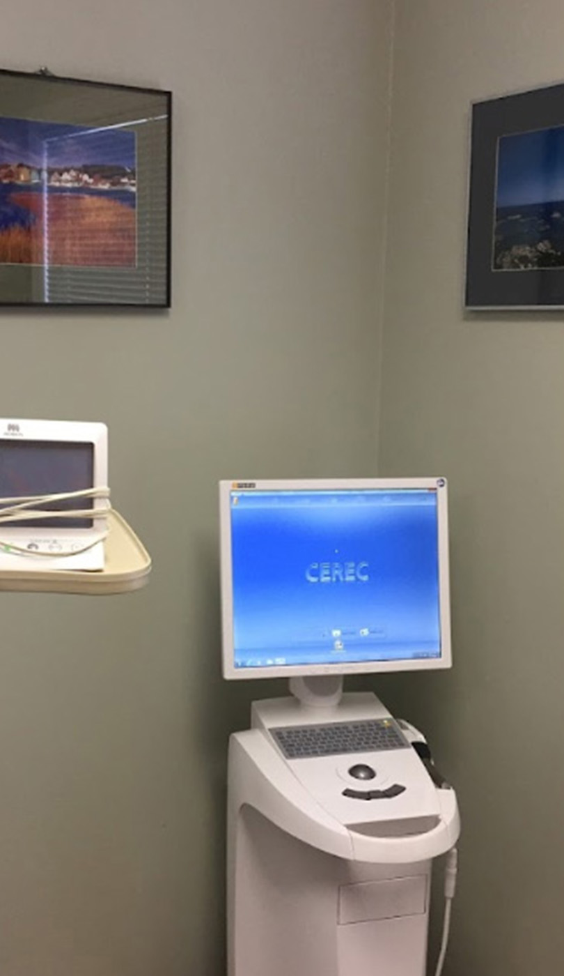 The image shows a modern dental or medical office interior with a dental chair, equipment, and a clean, professional environment.